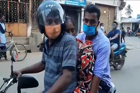 Man carries his mother on bike for cremation in Andhra Pradesh.