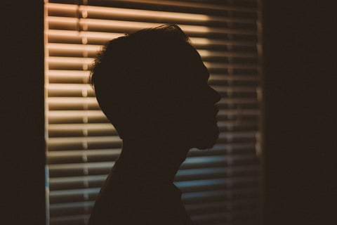Representative image of a silhouette of a man against a window