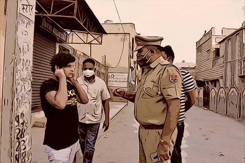 Man in black shirt being threatened by cops