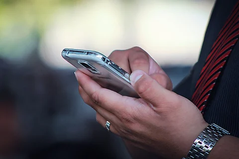 A representative image of a man using his phone