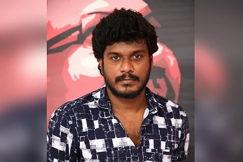 Actor Manikandan in black and white shirt