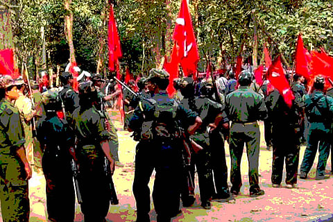 Maoists holding guns and flags in their hands