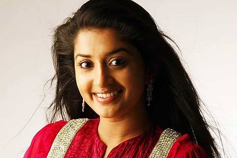 South Indian Meera Jasmine in a red dress