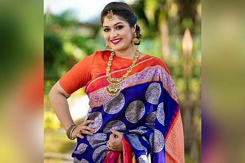 Meghana Raj Sarja in a blue saree with an orange blouse