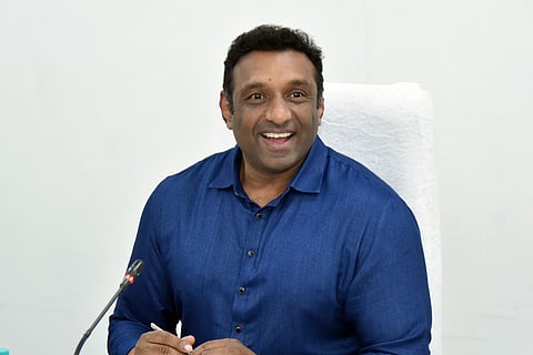 AP Industries and IT Minister Mekapati Gautham Reddy in a blue shirt smiling