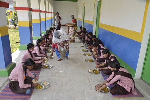 Students eating midday meals in a school
