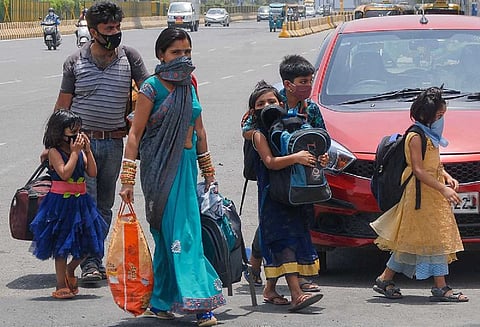 Migrant labourers going back home by foot