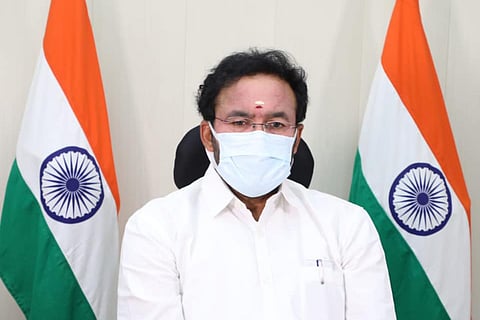 Minister Kishan Reddy flanked by India's national flag