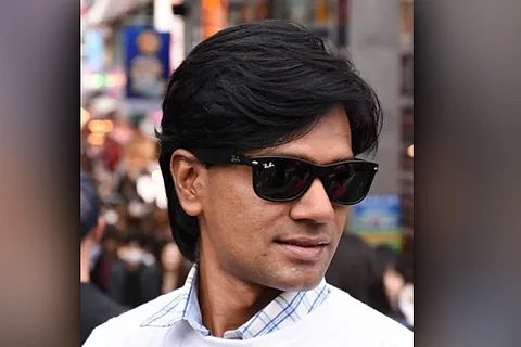 File image of Mohammed Zubair, co-founder of Alt news, wearing sunglasses and a white sweater over a collared shirt