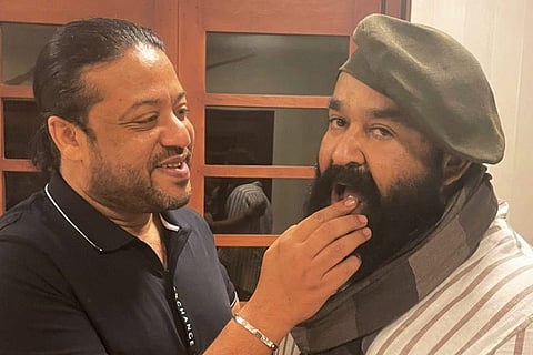 Mohanlal is seen eating his birthday cake and is sporting a new look in a long beard, with a scarf and French hat.