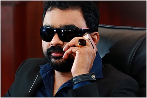Kerala faked antique collector Monson Mavunkal in a balck attire wearing stone studded ring