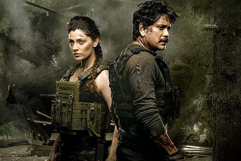 Saiyomi Kher and Nagarjuna dressed in black with smoke in the background