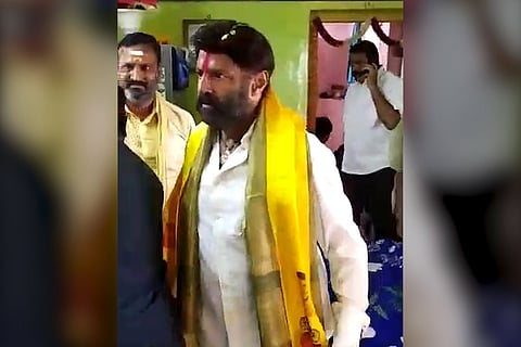 Actor and TDP MLA Balakrishna raising his hand to slap a man