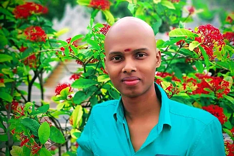 Cancer survivor Nandu Mahadeva in blue shirt