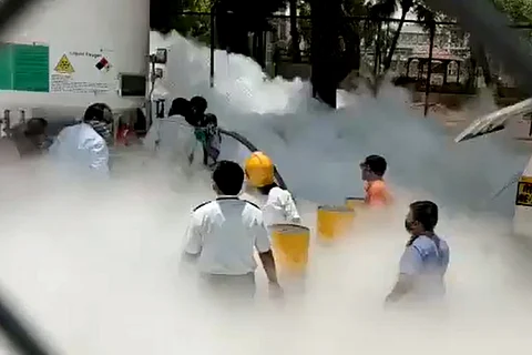 People standing amid smoke at the accident site