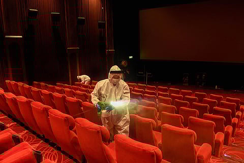 Workers sanitizing a theatre in New Delhi
