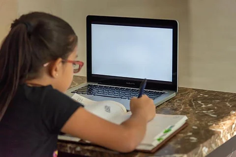 Girl sitting in front of laptop