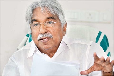 Oommen chandy wearing white shirt and specs