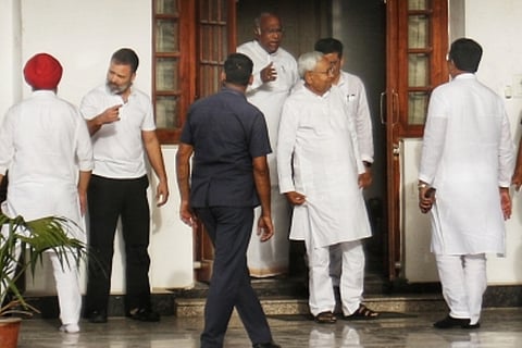 Kharge, Rahul Gandhi and others standing outside a building
