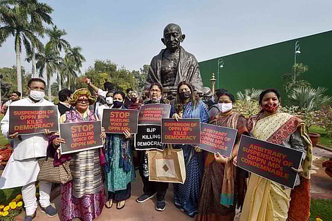 Members of opposition parties stage a protest at Parliament over the suspension of 12 Rajya Sabha MPs