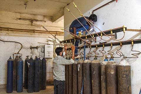 Workers at an oxygen filling station at Gauhati Medical College and Hospital