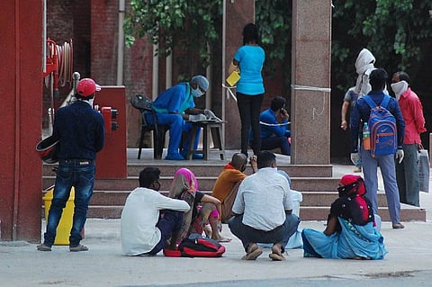 People sitting together outside a station