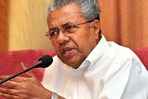Kerala CM Pinarayi Vijaan in a white shirt talking with a serious expression