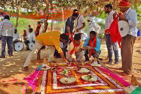 A group of Pambala priests perform ritual at a village deity.
