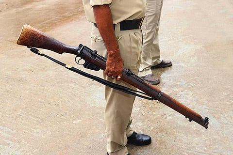 Police Officer Holding Gun