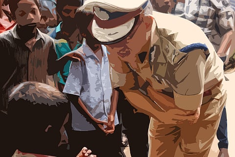 A police officer bending down to speak to a small boy