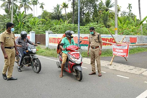 Police stopping a two wheeler to check e pass 