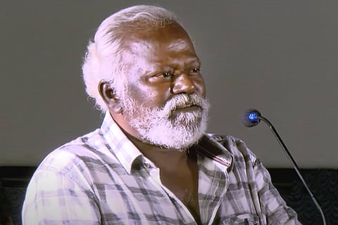 Actor Poo Ramu speaking in a mic
