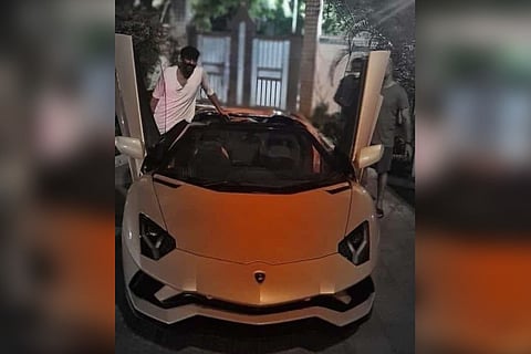 Actor Prabhas seen with his orange Lamborghini Aventador Roadster.