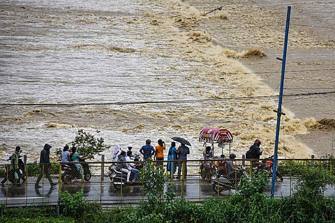 People visit Prakasam Barrage in Vijayawada as surplus water released into Krishna river following heavy rains