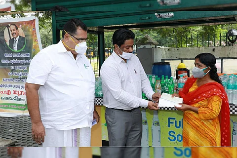 Lulu group's officials handing over money to Prasanna