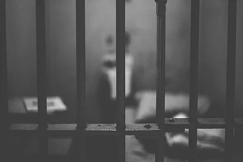 Silhoutte of a man inside a prison cell