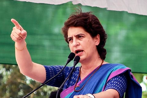 Priyanka Gandhi wearing a blue saree addressing a rally