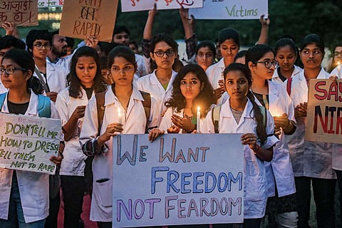 FIle image of students staging a candlelight march to protest against a rape and murder case