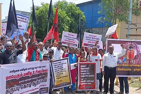 People protesting against Pattina Pravesam, holding banners, placards and black flags
