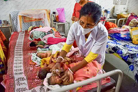 A health worker administering polio drops to an infant