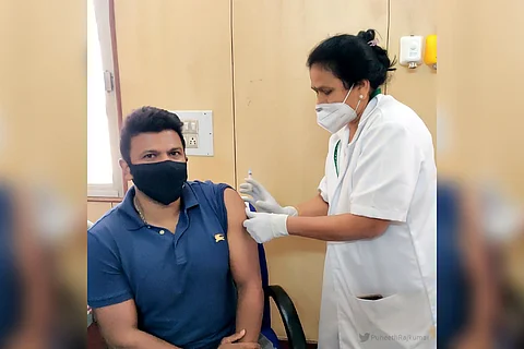 A nurse is seen administering vaccine to Puneeth Rajkumar.
