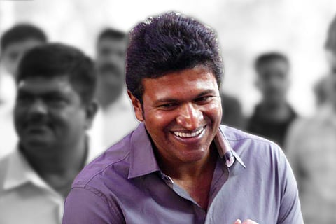 Puneeth Rajkumar in the foreground wearing a purple shirt