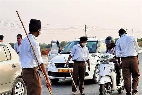 Images of lathi-wielding RSS workers checking vehicles in Telangana ignites row