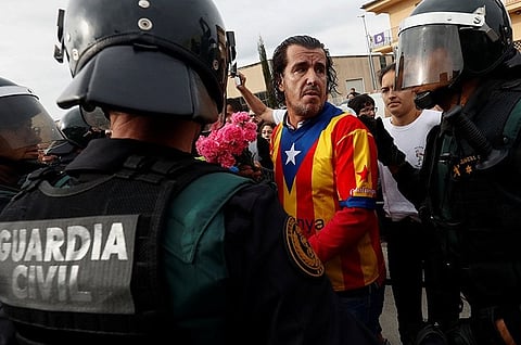 Catalan leader urges police withdrawal as Madrid defends crackdown