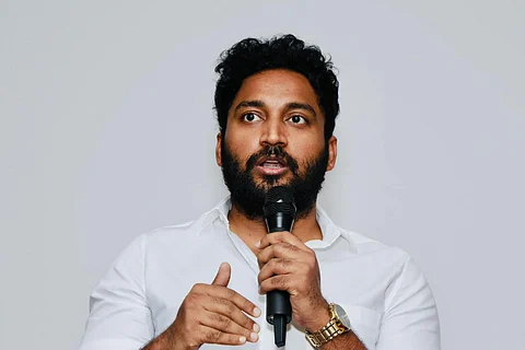 VCK deputy spokesperson Vikraman speaking into a mic
