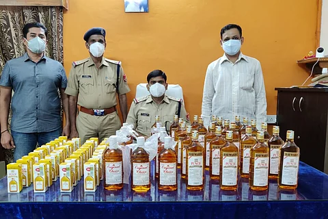 RPF officials with seized liquor