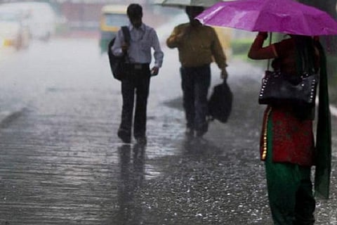 People walking on road during rain