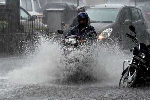 A bike passing through a flooded street
