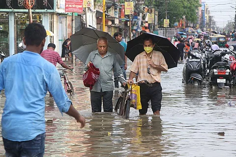 Representative image of people walking through flooded streets