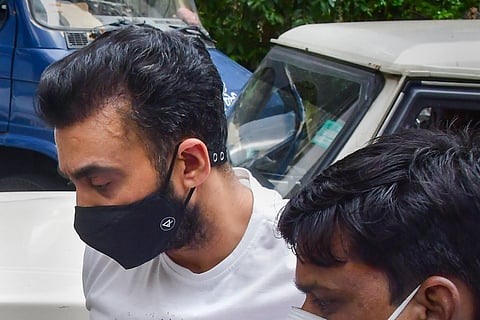 Raj Kundra being escorted by officials